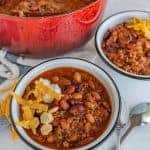 two bowls of chili in white bowls