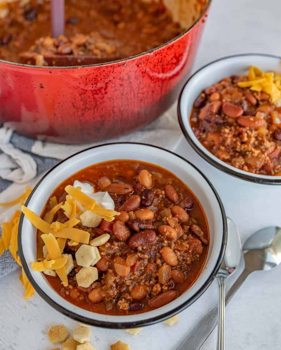 bowl of chili with a little cheese and a few crackers on top
