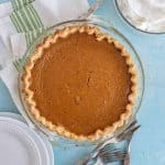 whole classic pumpkin pie in a clear pie dish