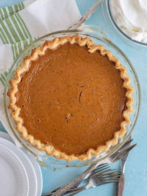 whole classic pumpkin pie in a clear pie dish