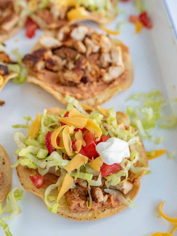 close up of chicken tostada on white plate