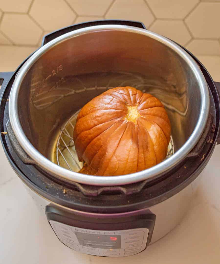 Learn how to cook pumpkin in the Instant Pot with this simple guide, so you can enjoy all the pumpkin soups, pies, and other fall recipes you and your family love! It's a cinch (and so fast) to cook pumpkin in the Instant Pot -- easy enough that you'll find yourself ditching the canned store-bought kind! #pumpkin #pumpkinpuree #pumpkinrecipes #pumpkininstantpot #instantpot #instantpotrecipes