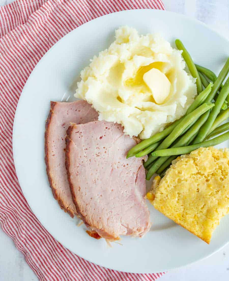 corn casserole green beans mashed potatoes on a white plate