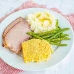 corn casserole green beans mashed potatoes on a white plate