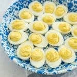 deviled eggs on a blue and white plate