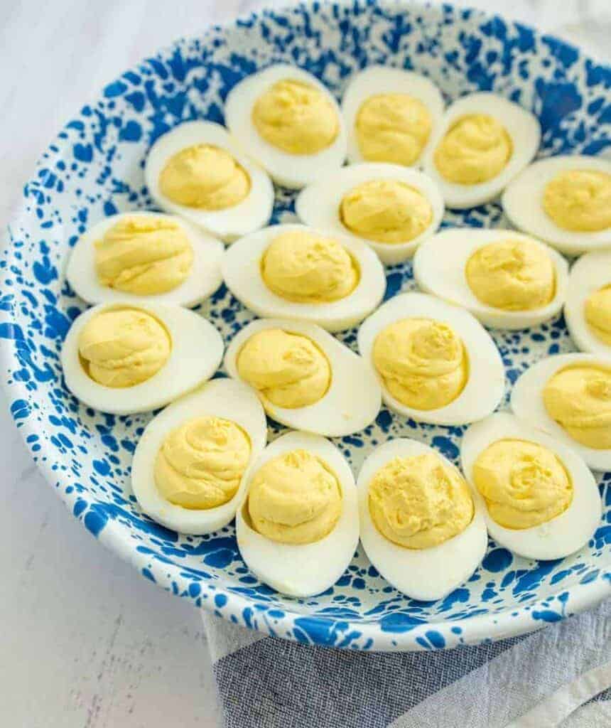 deviled eggs on a blue and white plate