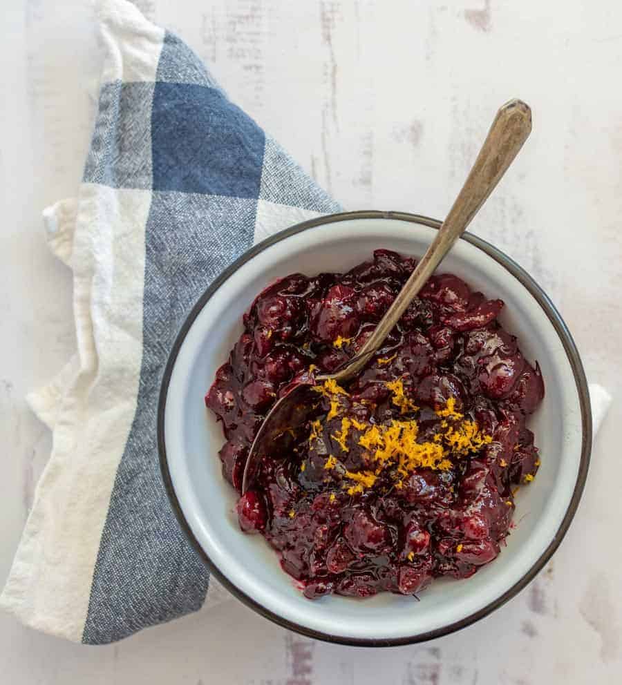 Sweet and tart with some citrusy tang, this easy homemade cranberry sauce is heavenly on a holiday dinner plate and is a simple side to prepare ahead of time! Simmering together a handful of ingredients on the stove is all it takes to make an irresistible cranberry sauce that you'll be dying to make for every holiday celebration! #cranberrysauce #cranberries #cranberrysaucerecipe #thanksgivingrecipe #thanksgivingdish #thanksgivingside #holidayrecipes