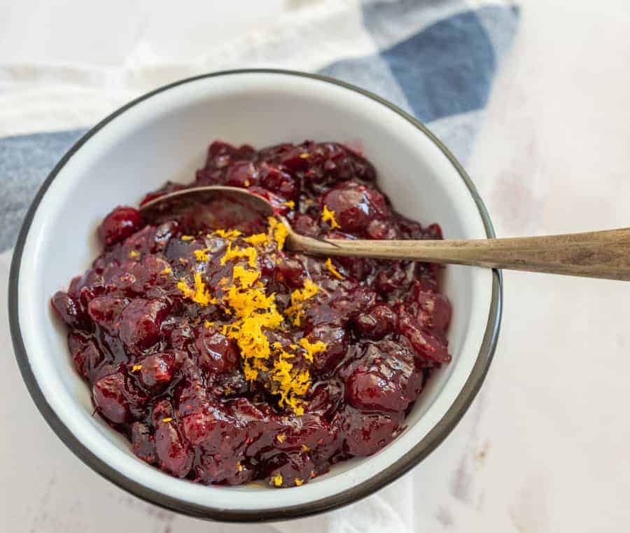 Sweet and tart with some citrusy tang, this easy homemade cranberry sauce is heavenly on a holiday dinner plate and is a simple side to prepare ahead of time! Simmering together a handful of ingredients on the stove is all it takes to make an irresistible cranberry sauce that you'll be dying to make for every holiday celebration! #cranberrysauce #cranberries #cranberrysaucerecipe #thanksgivingrecipe #thanksgivingdish #thanksgivingside #holidayrecipes