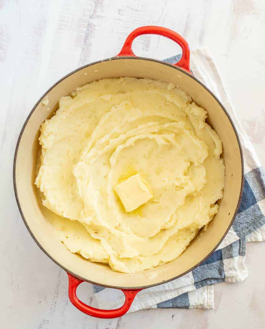 No holiday table is complete without a batch of classic, buttery mashed potatoes, and this recipe is perfectly easy to make and yields a heavenly and fluffy bowl of mashed potatoes. Using russet potatoes and butter with a few other simple ingredients, you can have the best homemade mashed potatoes for your holiday table or any other occasion. #mashedpotatoes #homemademashedpotatoes #mashedpotatorecipe #russetpotatoes #potatoes #potatorecipe #thanksgiving #thanksgivingdishes #thanksgivingrecipe