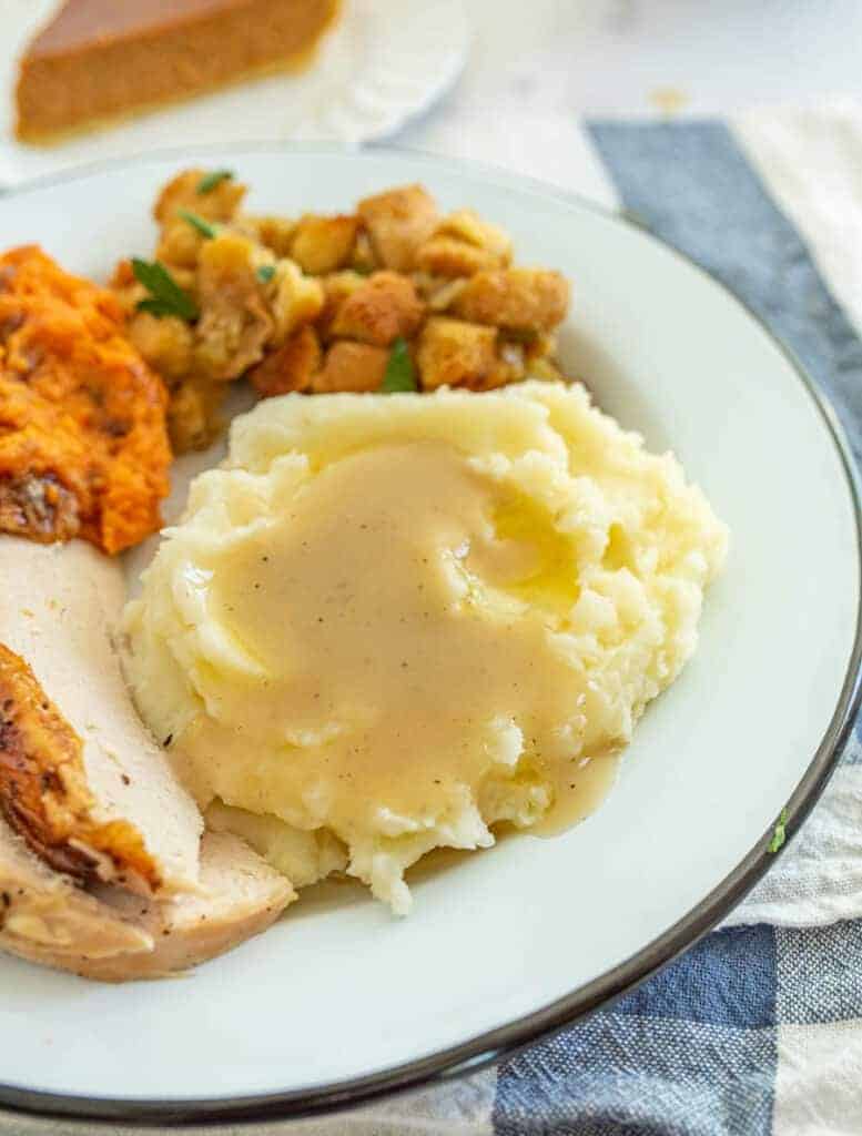 mashed potatoes and gravy on a white circular plate