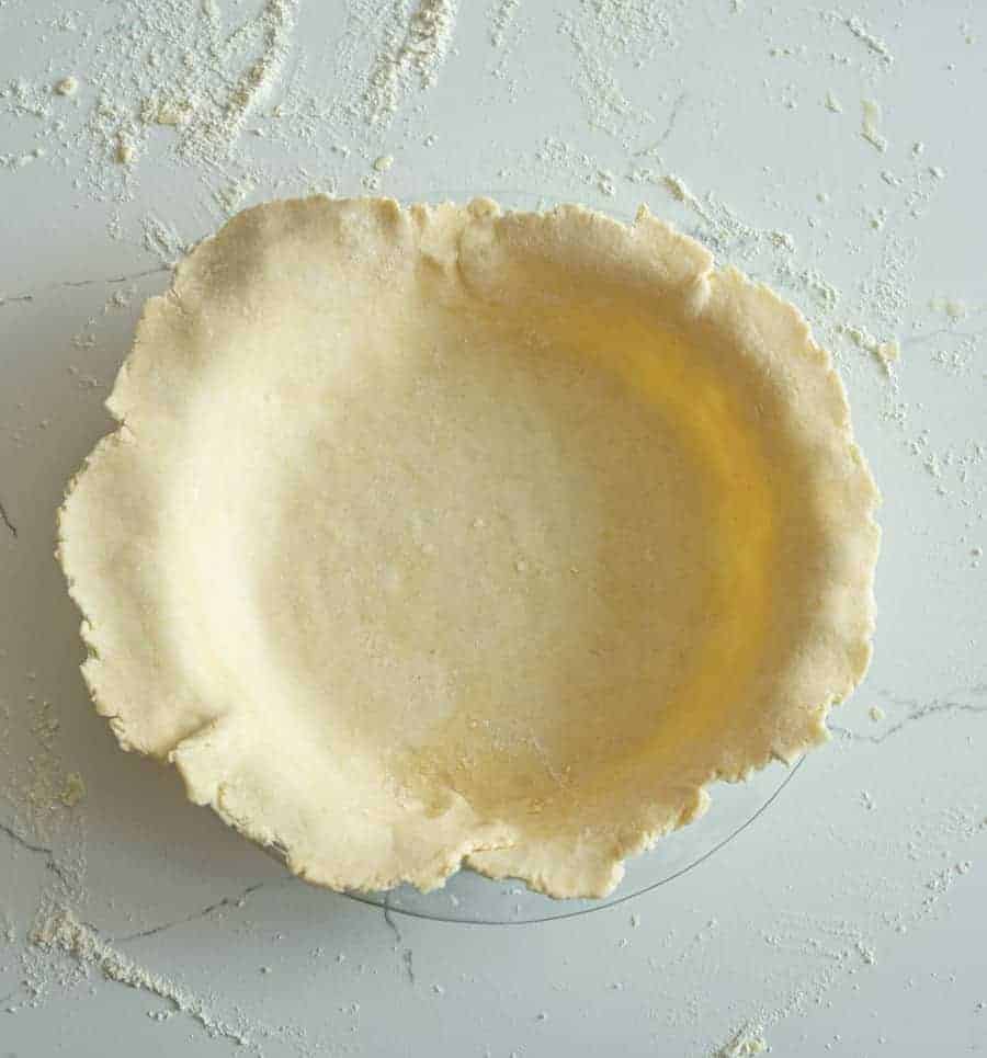 rolled out homemade pie crust laid into the pie dish