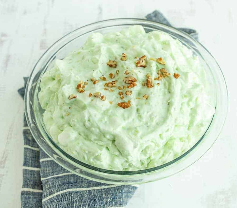 This 4 ingredient pistachio salad is a perfect and easy sweet salad for your holiday meal, and it takes just a few minutes to make! Don't let the green color fool you -- this is a perfect sweet salad to complement all the savory dishes served up for holiday meals, and it comes together so easily! #pistachiosalad #pistachiosaladrecipe #homemadepistachiosalad #pistachiopudding #holidaydishes #thanksgivingdishes #fruitsalad #ambrosiasalad #thanksgivingrecipes