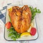 Whole roasted turkey on rectangular white dish