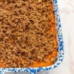sweet potato casserole in a white and blue pan.