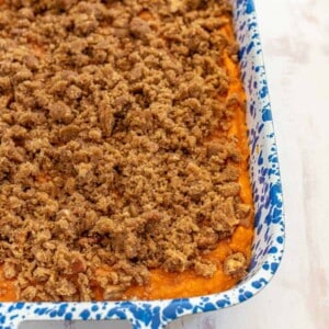 sweet potato casserole in a white and blue pan.