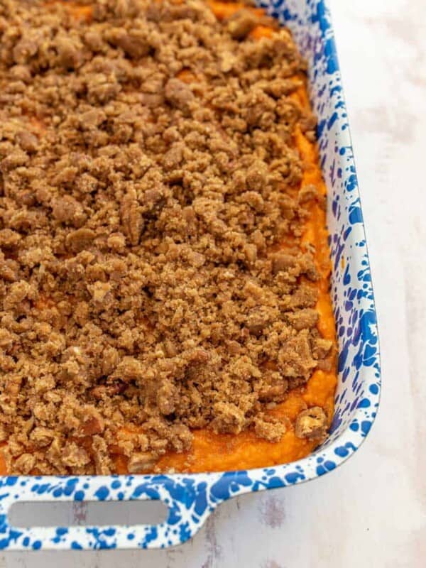 sweet potato casserole in a white and blue pan.