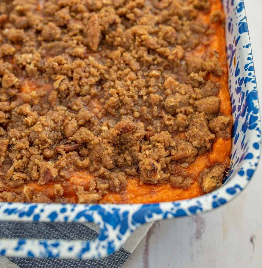 Sweet and fluffy sweet potatoes topped with a crunchy pecan streusel topping, Beth's famous sweet potato casserole is a must-make dish for holiday meals! #sweetpotatocasserole #thanksgivingsides #holidaydishes #sweetpotato #casserole #thanksgivingfood #thanksgivingrecipes #holidayrecipes 