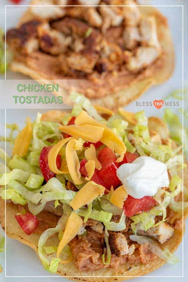 Title Image for Chicken Tostadas and a chicken tostada topped with chicken, shredded lettuce, shredded cheese, diced tomato and sour cream