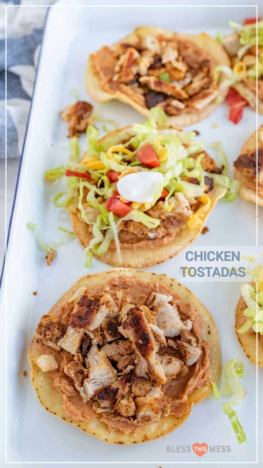 The best chicken tostadas take only 30 minutes to make, including simple baked tostada shells, and the whole family will love them. They come together quickly and they're bursting with flavor, which is kind of the best thing ever when it comes to weeknight meals. #tostadas #chickentostadas #tacos #texmex #mexicanfood #tostadarecipe