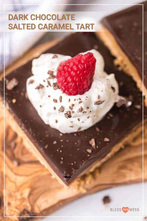 Title Image for Dark Chocolate Salted Caramel Tart and a square serving of tart crust with dark chocolate layer, whipped cream and a raspberry on top