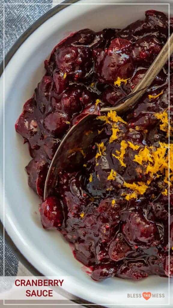 A bowl of homemade cranberry sauce topped with orange zest