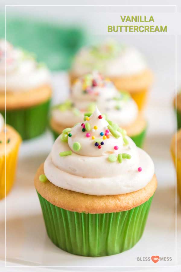 Title Image for Vanilla Buttercream and a vanilla cupcake in a green wrapper with a swirl of vanilla frosting and colorful sprinkles