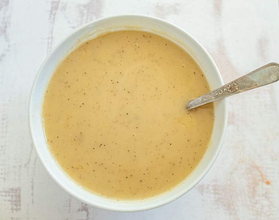 This simple and flavorful homemade gravy comes together quickly using the leftover drippings from a roast turkey or roast turkey breast! You can simply whip this up in a few minutes before you serve a delicious holiday feast to family and friends with the use of a few pantry staple ingredients and the drippings from turkey! #gravy #turkeygravy #thanksgiving #thanksgivingrecipes #homemadegravy #gravyrecipe #holidayrecipes