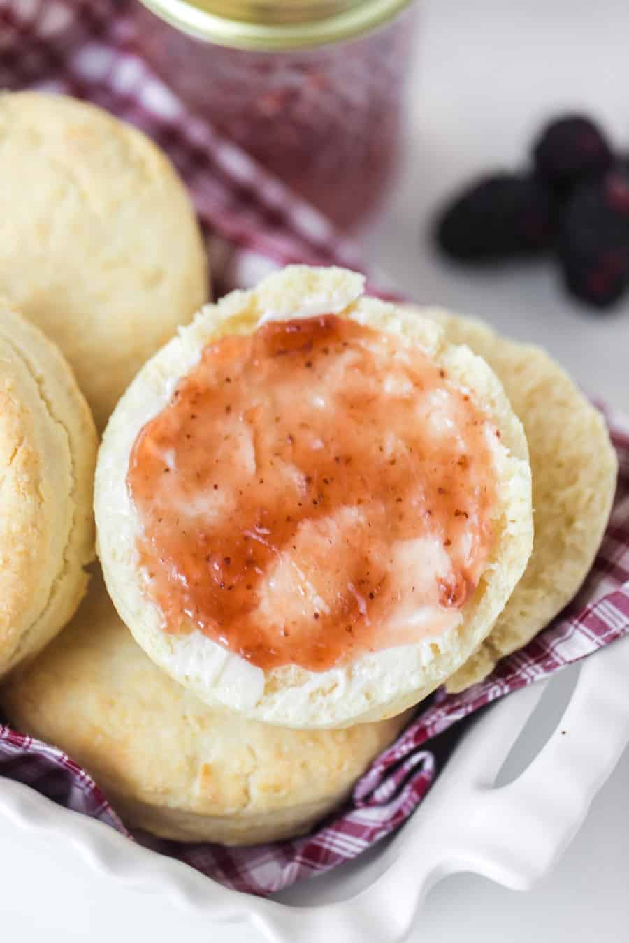 simple cream biscuits with jam in white dish