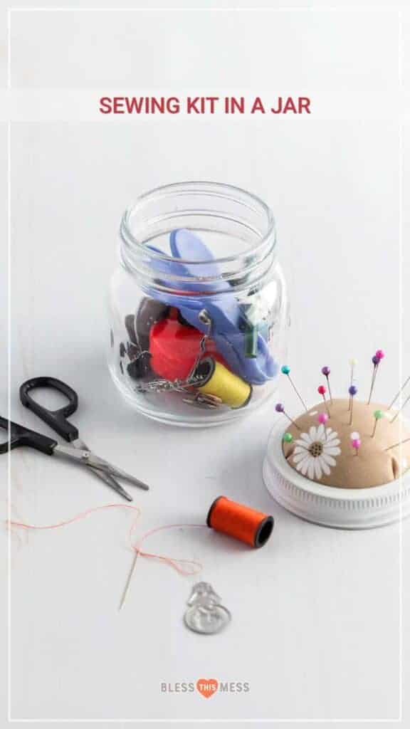 Title Image for Sewing Kit in a Jar, a pin cushion with pins, a needle and thread, scissors, and a small mason jar filled with safety pins, thread, clips,