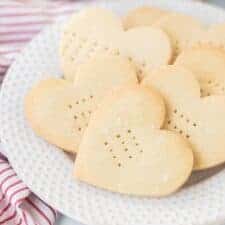 Shortbread Cookiesheart shaped shortbread cookies with fork punctures on a white plate