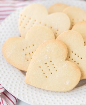 Shortbread Cookiesheart shaped shortbread cookies with fork punctures on a white plate