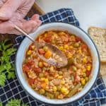 a spoon scooping out the word "yum" out of alphabet soup