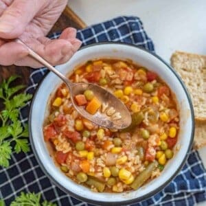 a spoon scooping out the word "yum" out of alphabet soup