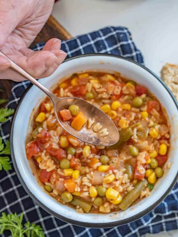 a spoon scooping out the word "yum" out of alphabet soup