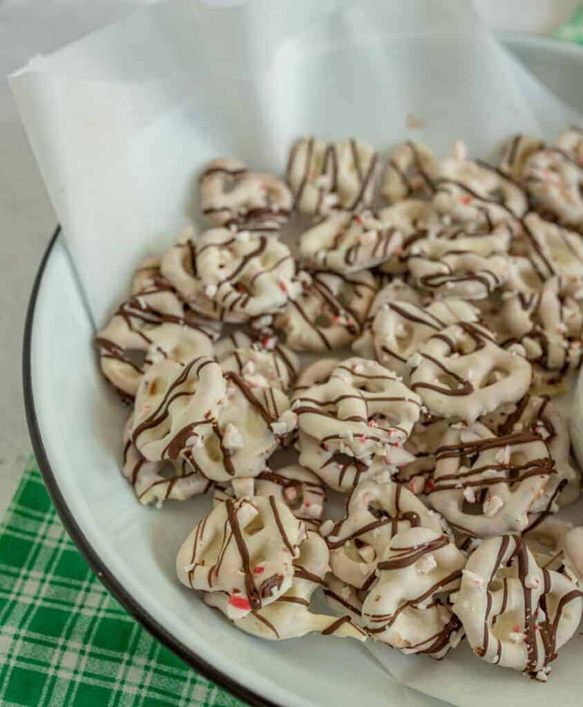 plate of pretzels with white chocolate drizzled with milk chocolate and sprinkled with broken candy canes