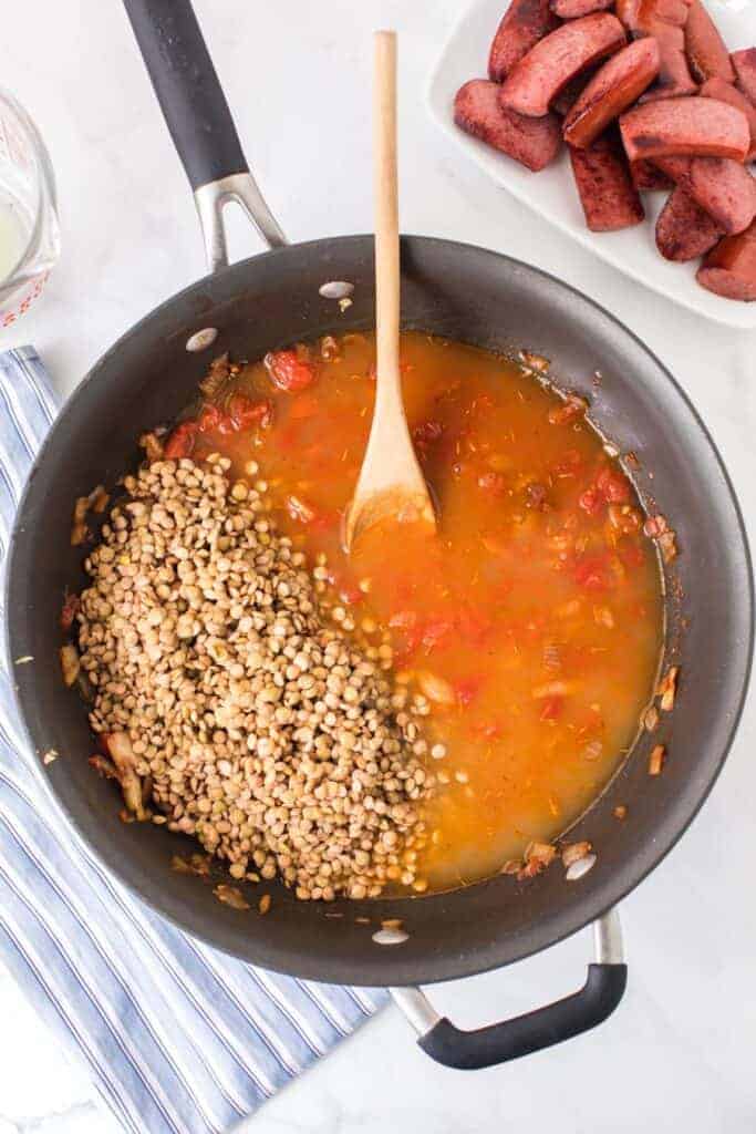 lentils and a tomato and spicy looking sauce in a pan