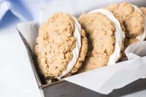 close up of the cookie-frosting-cookie view from a bread pan stacked with oatmeal cream pies