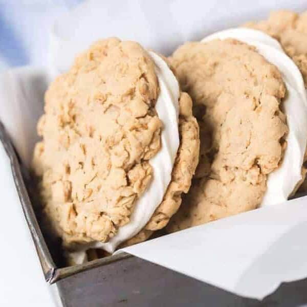 close up of the cookie-frosting-cookie view from a bread pan stacked with oatmeal cream pies