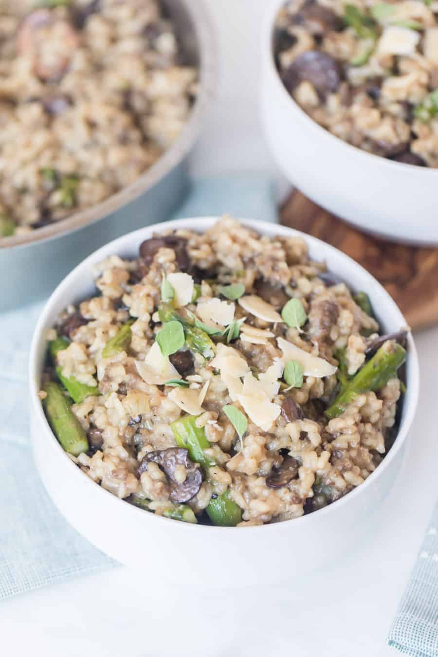Sausage Asparagus and Mushroom Risotto in white bowls