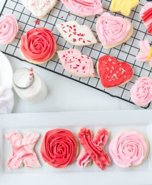 stack of valentines day sugar cookies with piped pink and red or lips or even X&O's made of frosting