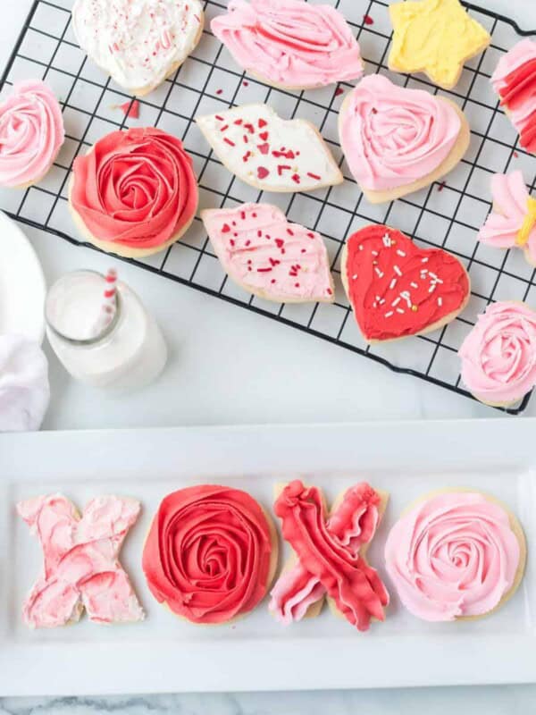 stack of valentines day sugar cookies with piped pink and red or lips or even X&O's made of frosting