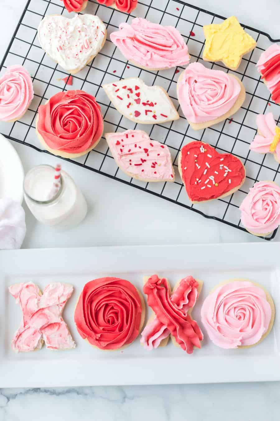 valentine's day iced sugar cookies in heart shape lip shape and circle cutout cookies on cooling rack