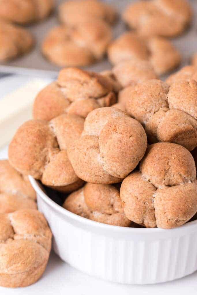 Whole wheat clover rolls are soft and fluffy whole grain dinner rolls that are made in a muffin tin and pull apart into three pieces which means more places to put the butter! They're seriously delicious, simple to make, and fun to have on hand for a quick snack, dinner side, or breakfast roll! #cloverrolls #wholewheatcloverrolls #wholewheatrolls #wholewheatbread #dinnerrolls #easyrolls