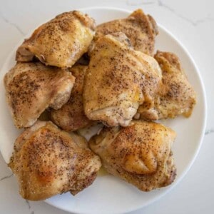 a pile of seasoned and cooked oven baked chicken thighs.
