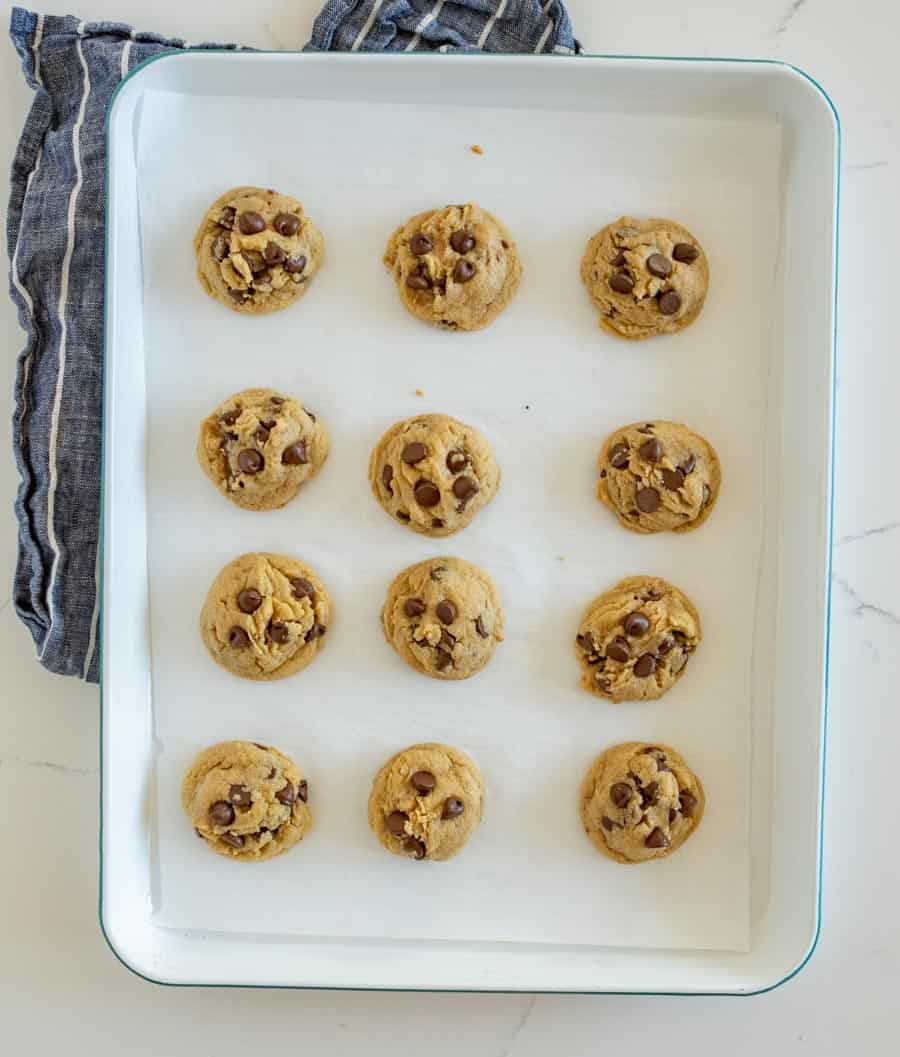 top view of baked chocolate chip cookies on a baking sheet in rows