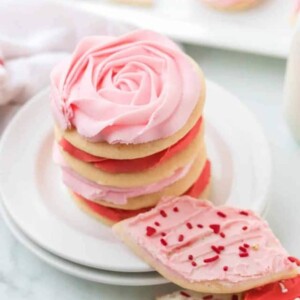 stack of valentines day sugar cookies with piped pink and red roses made of frosting