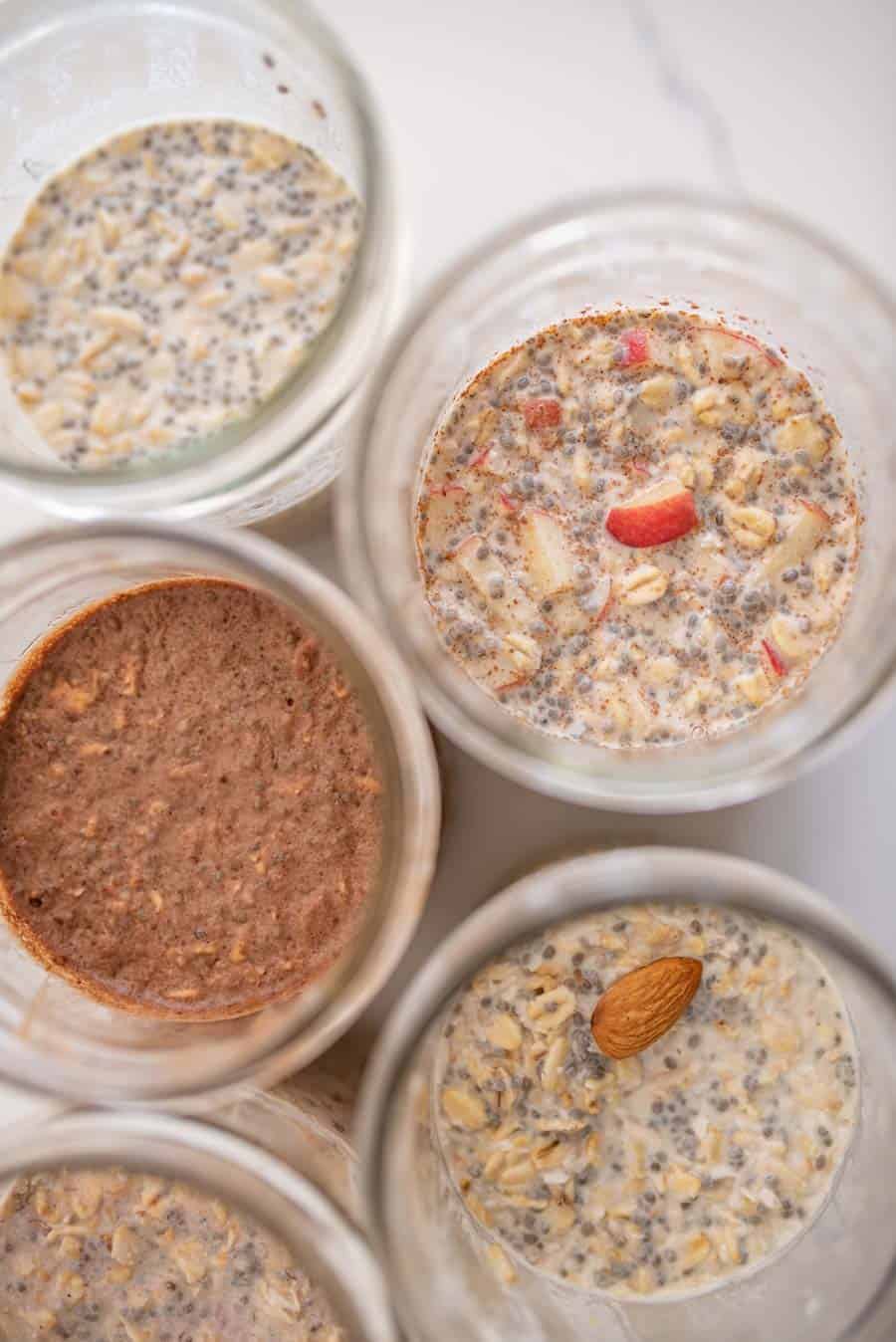 close up of 5 kinds of overnight oats in glass jars from the top