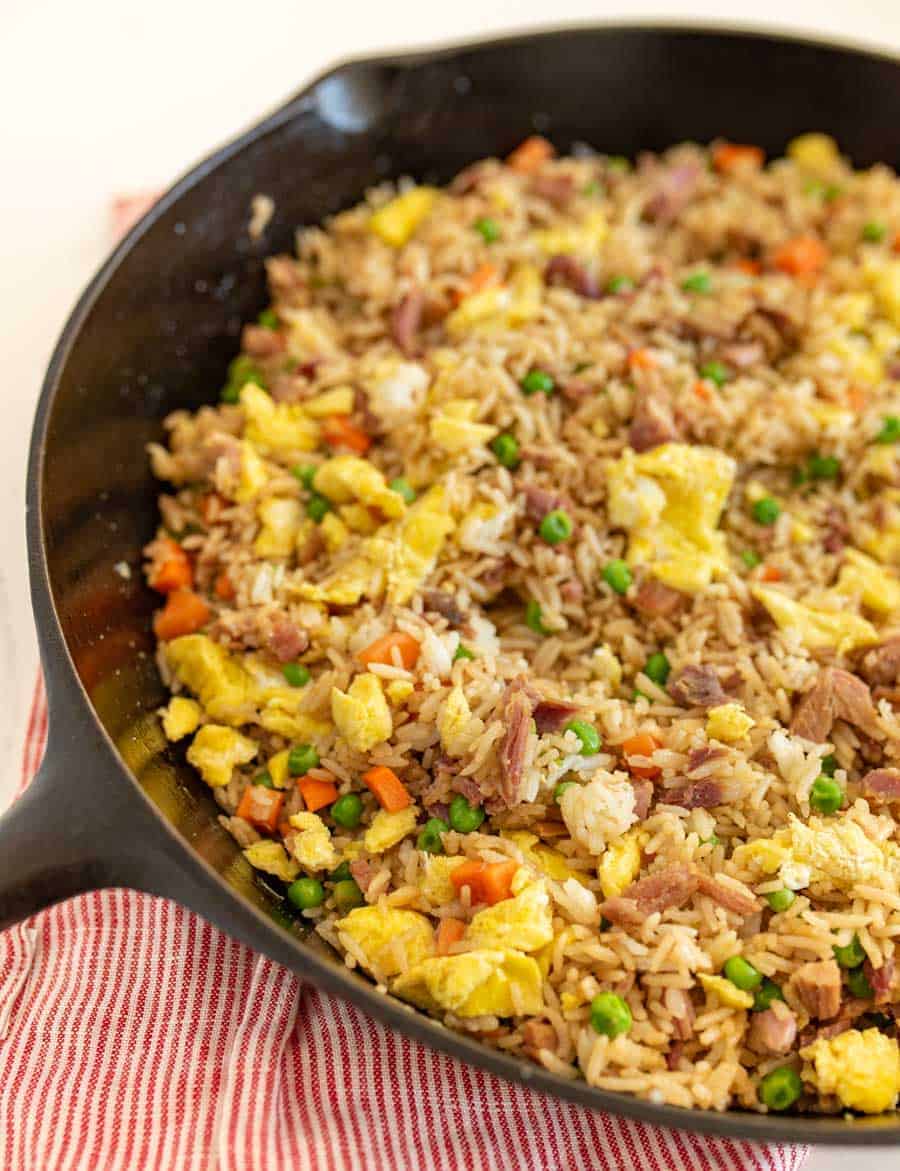 easy fried rice in a skillet on red and white striped towel