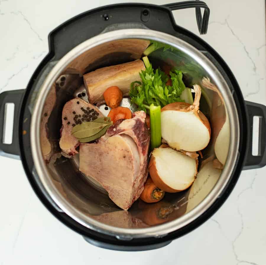 uncooked vegetables and bone in instant pot