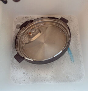 instant pot lid in the sink.